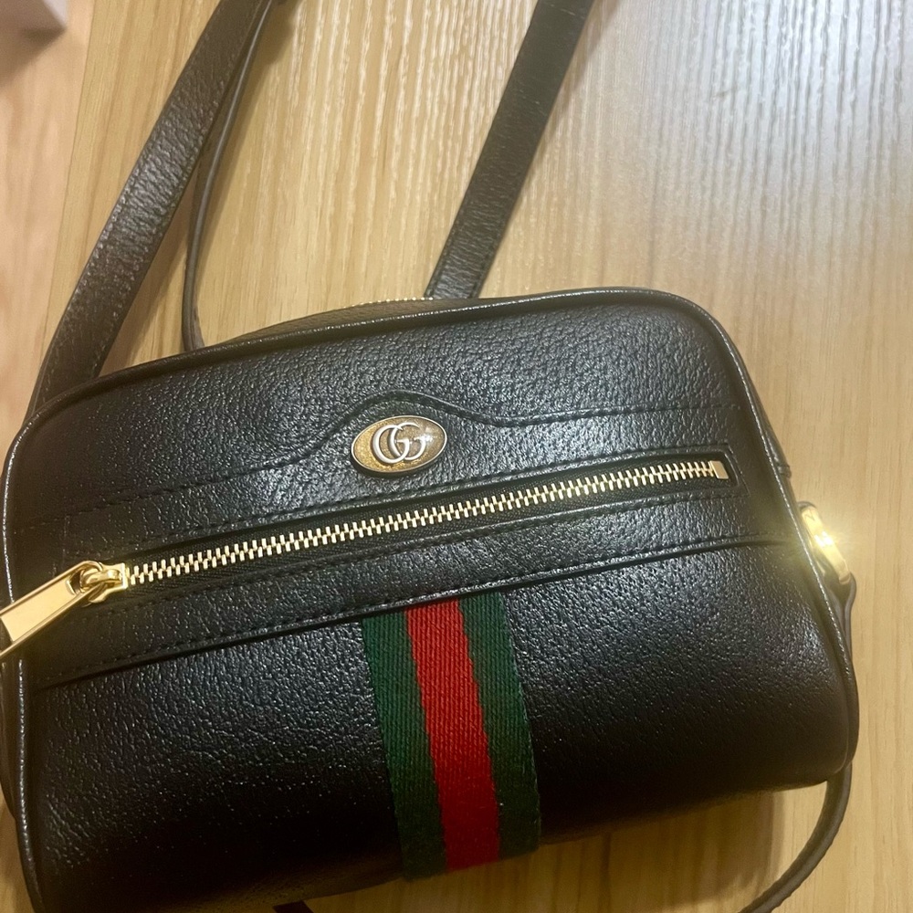 Gucci Black and Gold Crossbody Bag with Structured Design used once.